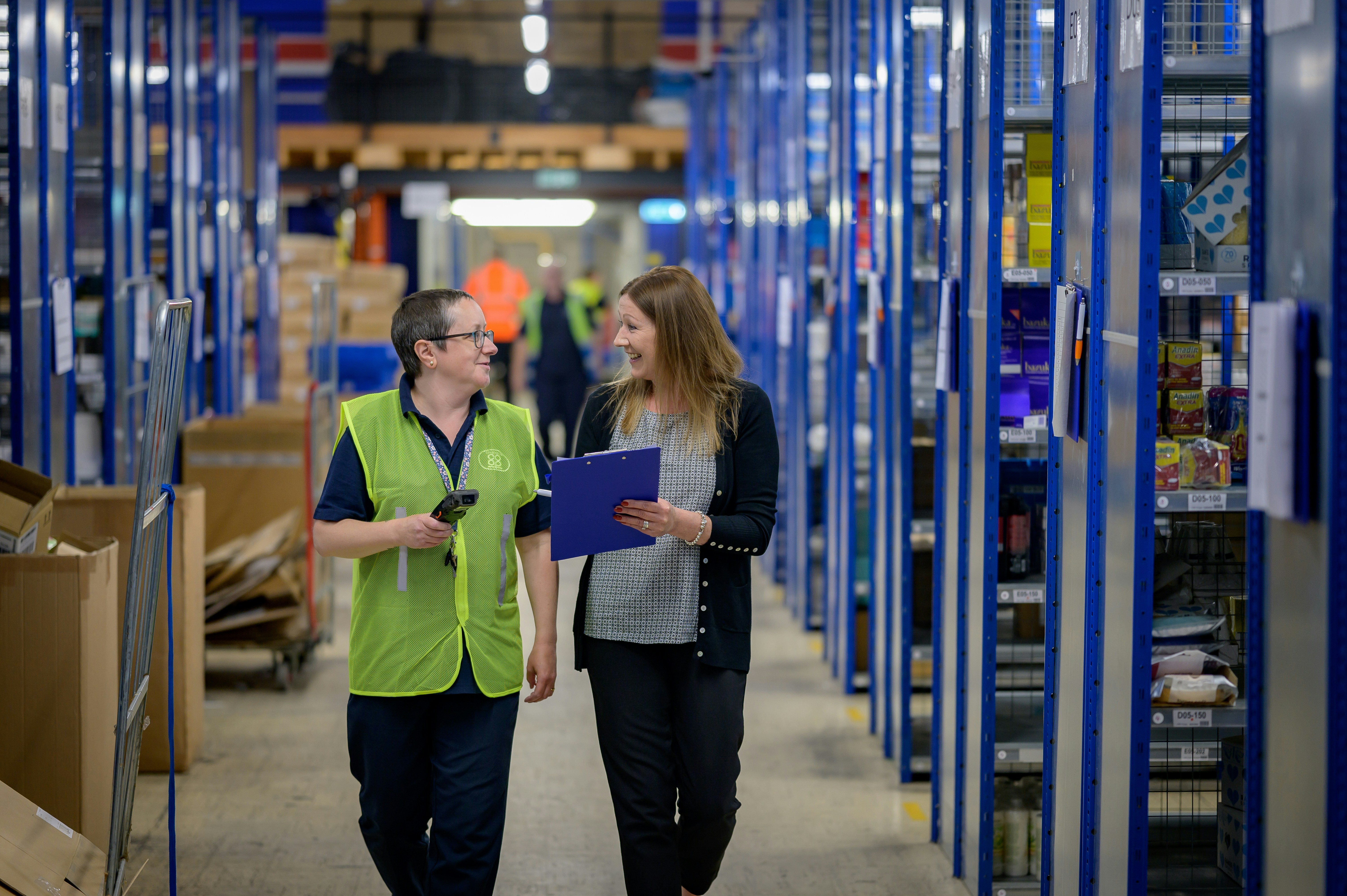 A safety manager and supervisor reviewing a compliance record on site